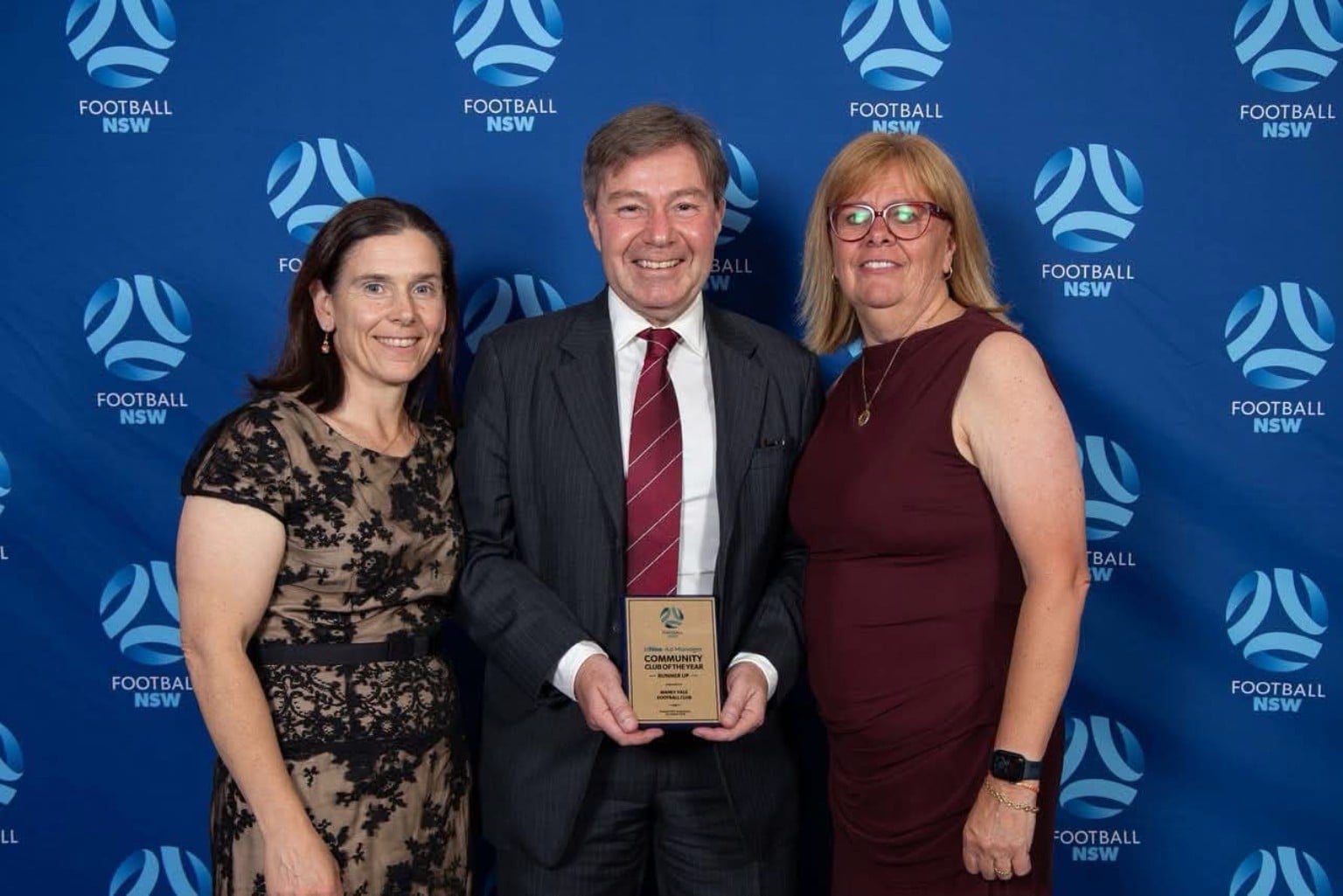 Roy Sider (centre) holding Manly Vale FC’s award, with his wife Angela on the left and Lee-Anne Sestanovich on the right.