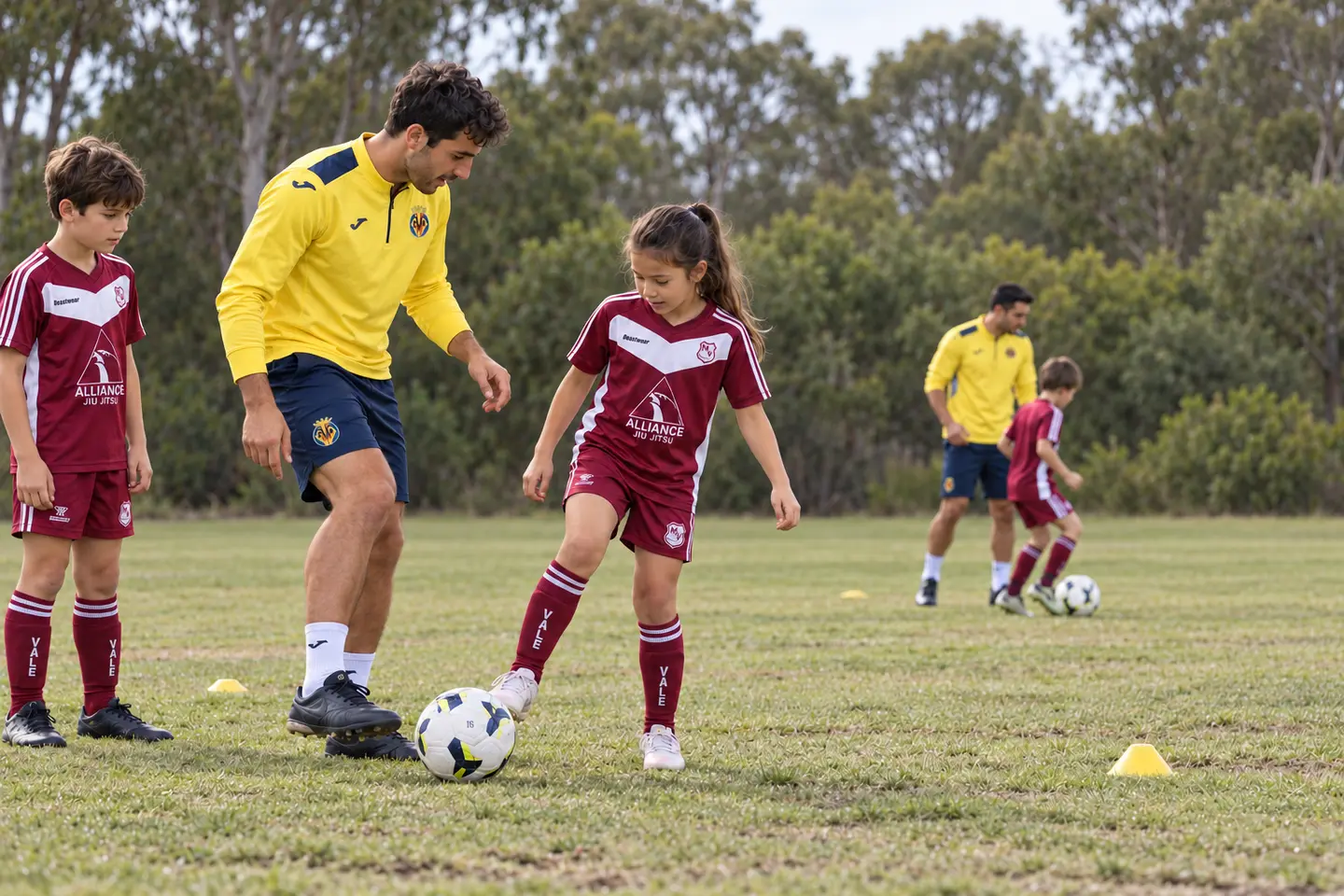 Illustration of Villarreal Academy coaches teaching junior players in Manly Vale's maroon and white chevron kit.